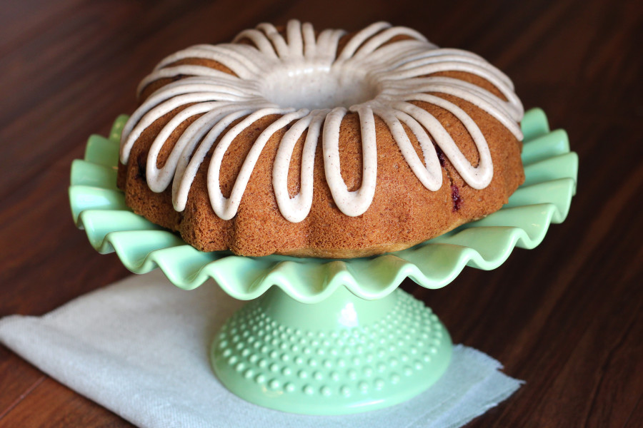 Gluten Free Vegan Apple Cranberry Bundt Cake. Moist apple cake, studded with fresh cranberries and topped with a cinnamon glaze.