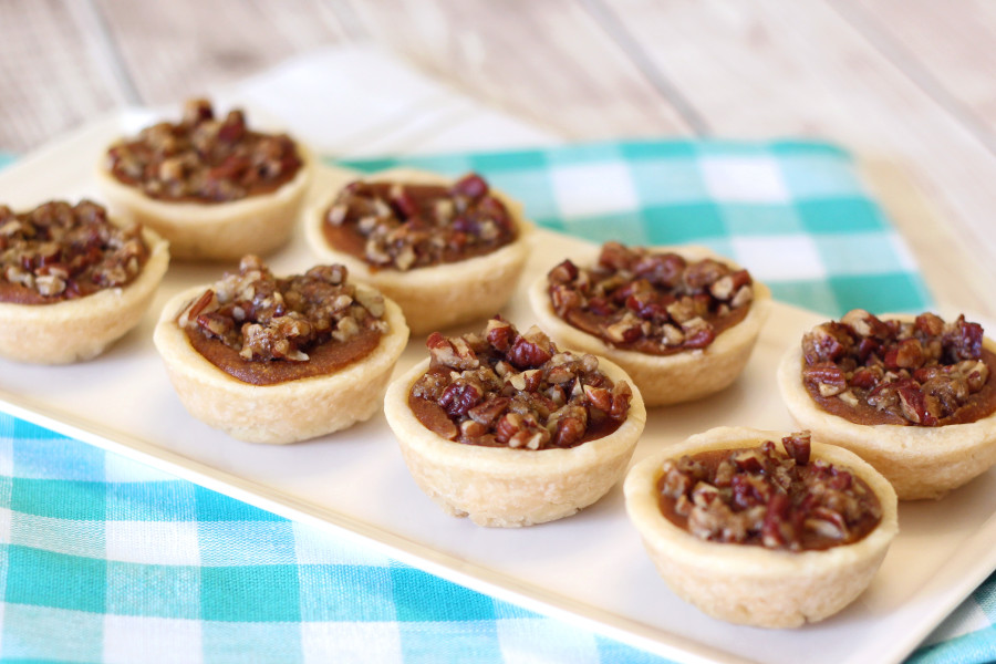 Gluten Free Vegan Mini Pumpkin Pecan Tartlets. Flakey crust, pumpkin filling and sugary pecans. Bite size deliciousness!