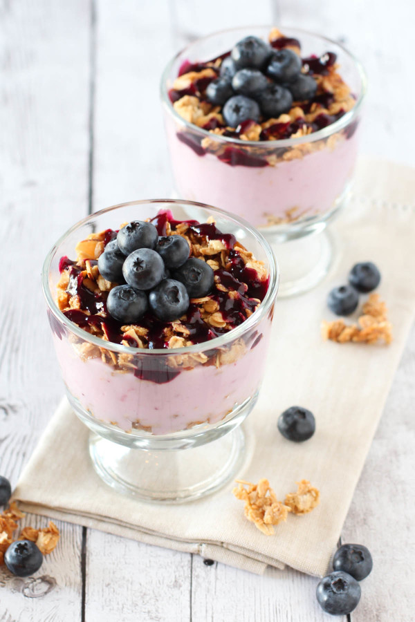 Gluten Free Vegan Blueberry Breakfast Parfaits. Crunchy almond granola, creamy dairy free yogurt with a homemade blueberry sauce!