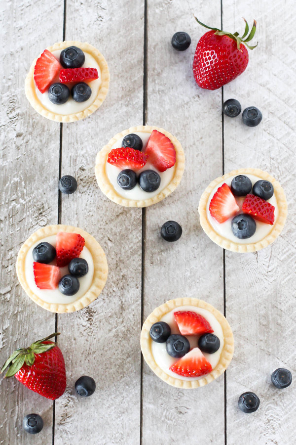 Gluten Free Vegan Mini Fresh Fruit Tarts. Light pastry, filled with lemon cream pudding and topped with fresh berries. A splendid spring dessert! 