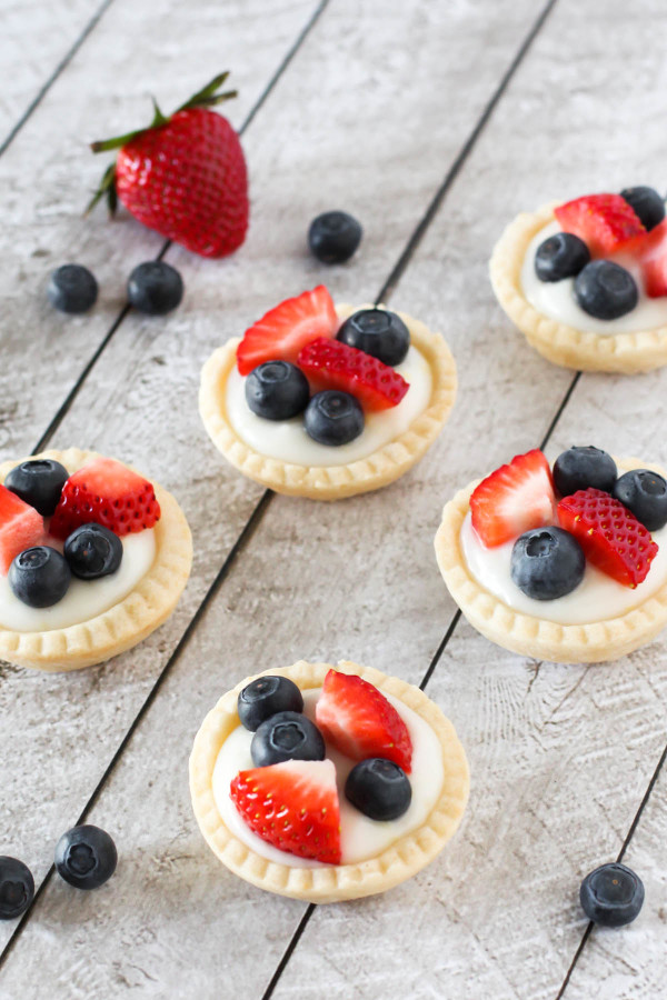 Gluten Free Vegan Mini Fresh Fruit Tarts. Light pastry, filled with lemon cream pudding and topped with fresh berries. A splendid spring dessert! 