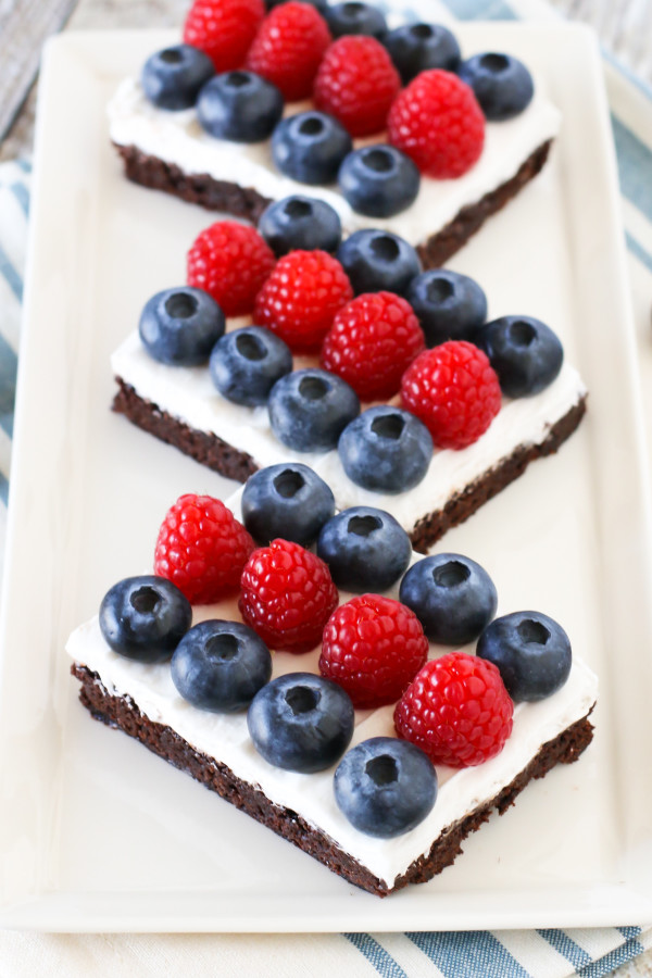 Gluten Free Vegan Berries and Cream Brownies. Fudgy brownies, topped with dairy free Cocowhip and rows of fresh berries. A deliciously patriotic dessert!