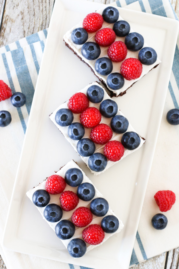 Gluten Free Vegan Berries and Cream Brownies. Fudgy brownies, topped with dairy free Cocowhip and rows of fresh berries. A deliciously patriotic dessert!