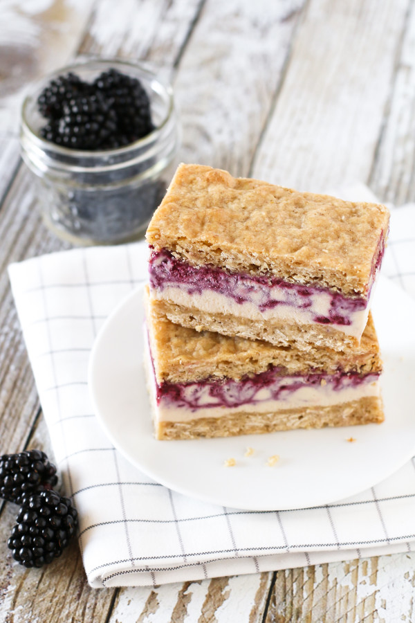 Gluten Free Vegan Blackberry Crisp Ice Cream Sandwiches. Creamy blackberry swirled cashew milk ice cream, sandwiched between two oatmeal crisp cookies. 