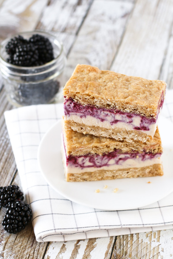 Gluten Free Vegan Blackberry Crisp Ice Cream Sandwiches. Creamy blackberry swirled cashew milk ice cream, sandwiched between two oatmeal crisp cookies. 