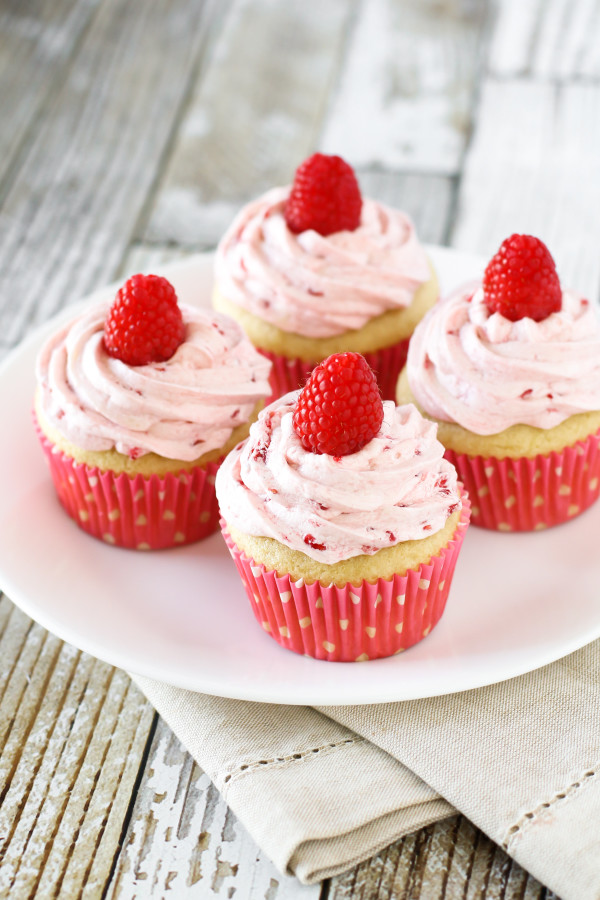 Gluten Free Vegan Raspberry Vanilla Cupcakes. Fluffy vanilla cupcake, topped with a fresh raspberry buttercream. Delightful!