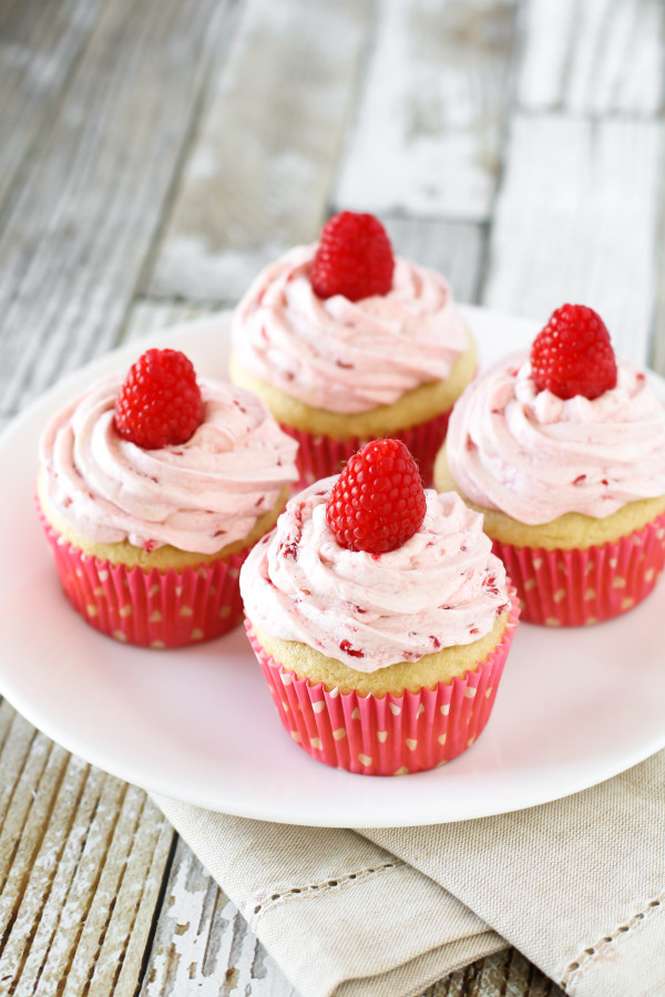 Gluten Free Vegan Raspberry Vanilla Cupcakes. Fluffy vanilla cupcake, topped with a fresh raspberry buttercream. Delightful!