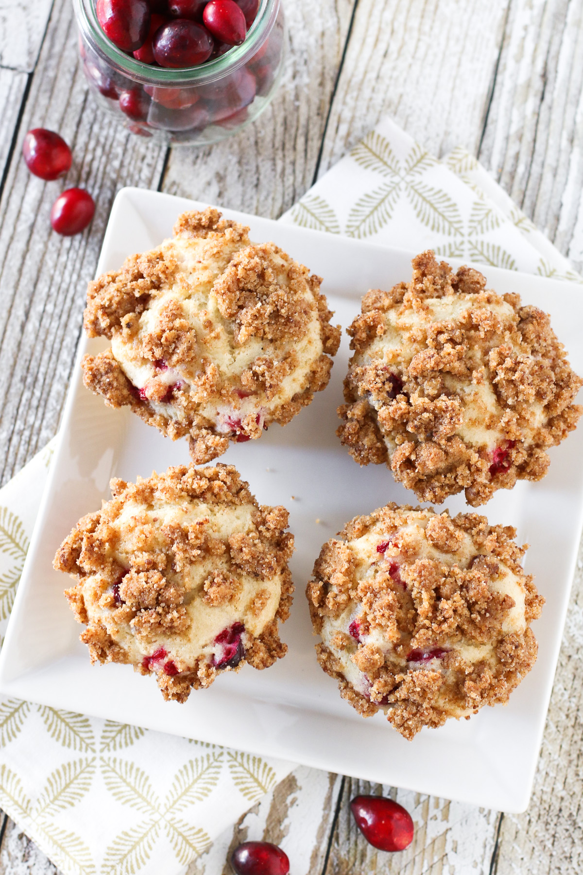 Gluten Free Vegan Cranberry Coffeecake Muffins. Fluffy vanilla cake, studded with fresh cranberries and topped with a crunchy cinnamon topping.