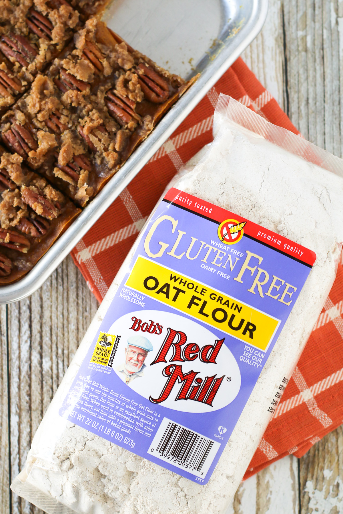 Gluten Free Vegan Pecan Pumpkin Pie Bars. Oat crust made with Bob's Red Mill gluten free oat flour, creamy pumpkin filling and sugar crumble pecan topping.