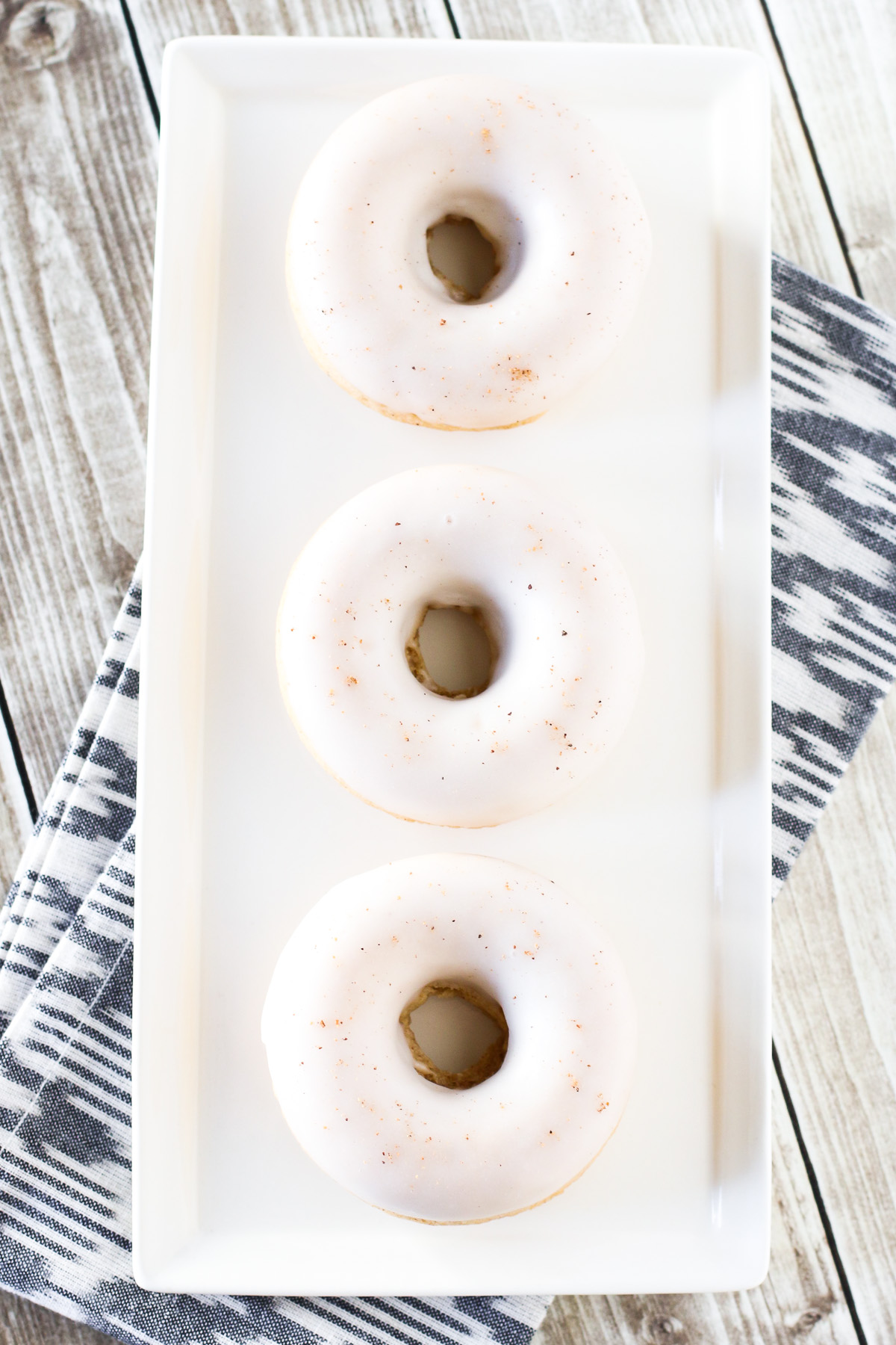 Gluten Free Vegan Baked Eggnog Donuts. Holiday flavor of creamy eggnog in these fluffy baked donuts.