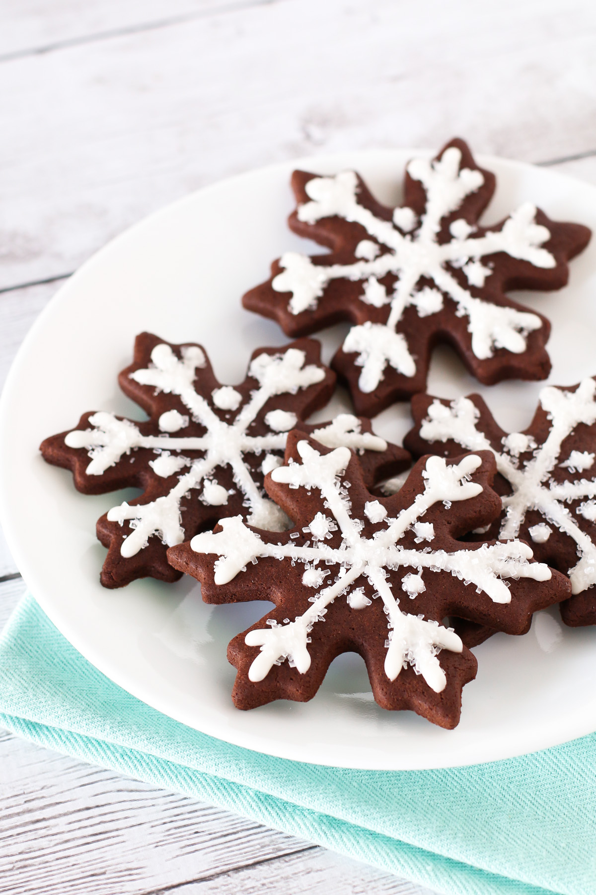 Gluten Free Vegan Chocolate Snowflake Sugar Cookies. Decorated with a simple glaze and sparkling sugar. Such a beautiful, magical Christmas cookie!