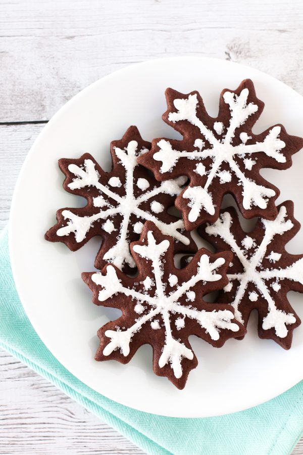 Gluten Free Vegan Chocolate Snowflake Sugar Cookies. Beautiful chocolate snowflakes, with a simple glaze and sparkling sugar.