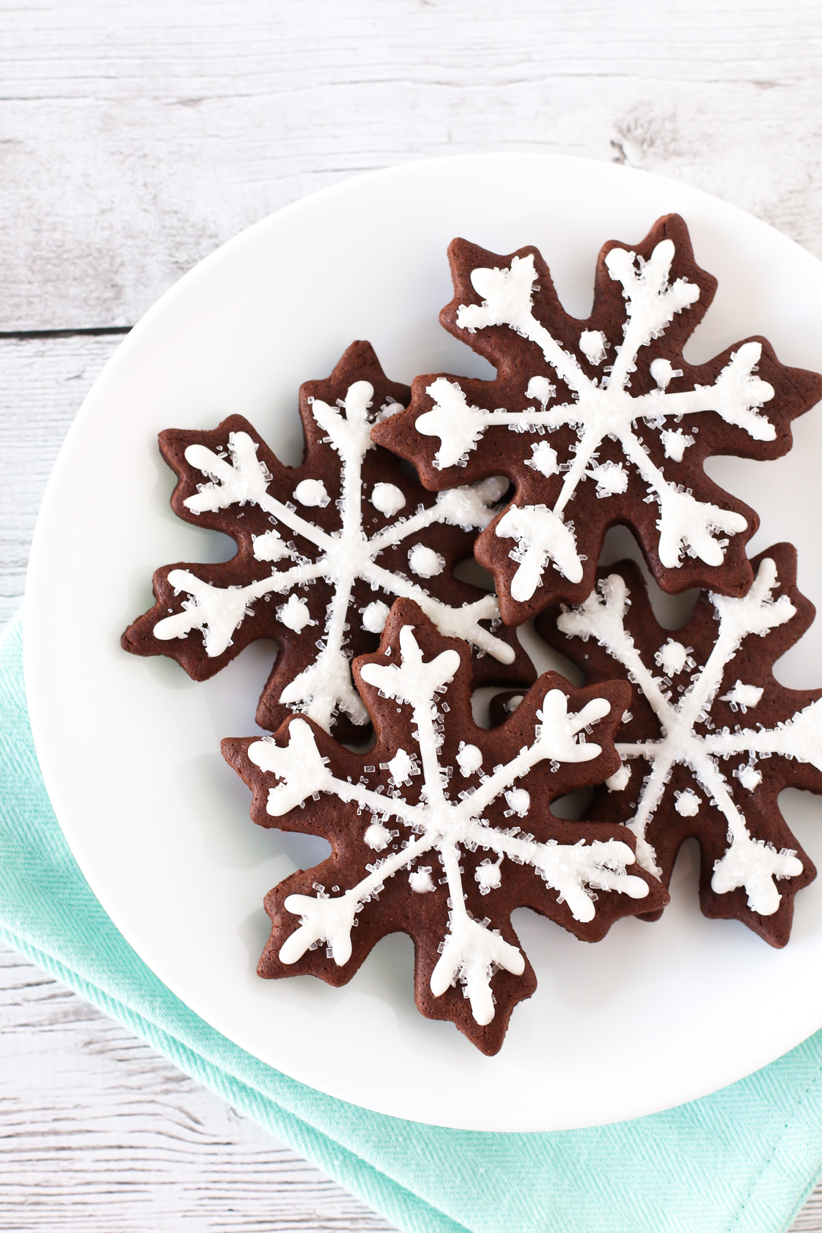 Gluten Free Vegan Chocolate Snowflake Sugar Cookies. Decorated with a simple glaze and sparkling sugar. Such a beautiful, magical Christmas cookie!