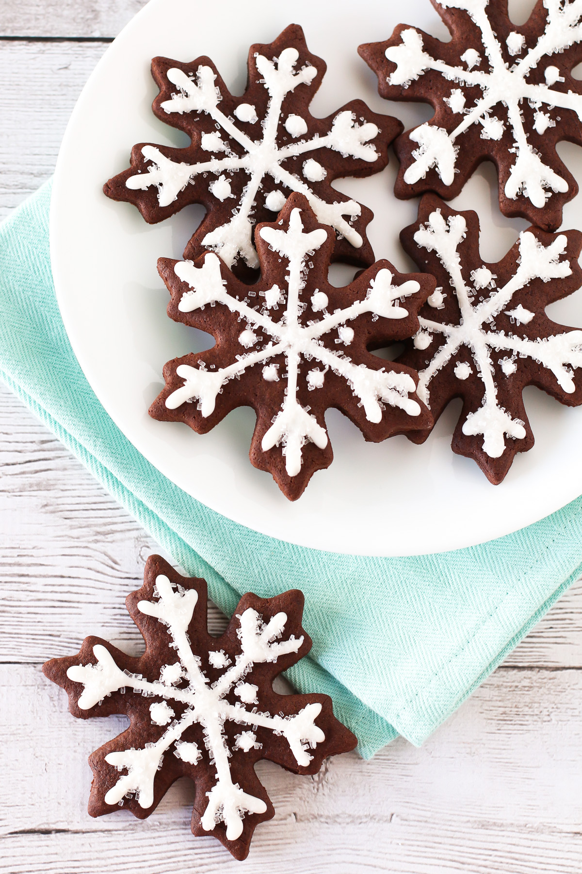 Gluten Free Vegan Chocolate Snowflake Sugar Cookies. Beautiful chocolate snowflakes, with a simple glaze and sparkling sugar. Oh so festive!