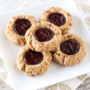 Gluten Free Vegan Raspberry Thumbprint Cookies. Tender almond cookies with a raspberry jam filling. A holiday classic!