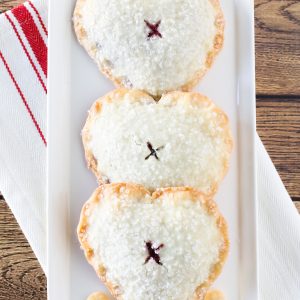 Heart-shaped flakey pie crust, filled with sweet, dark cherry filling. These gluten free vegan sweetheart cherry hand pies are all kinds of adorable!