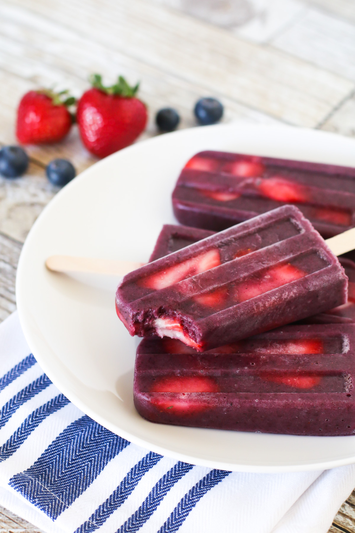 Berry Smoothie Popsicles. These perfect for summer smoothie popsicles are made with blueberries, bananas, flaxmilk and slices of fresh strawberries.