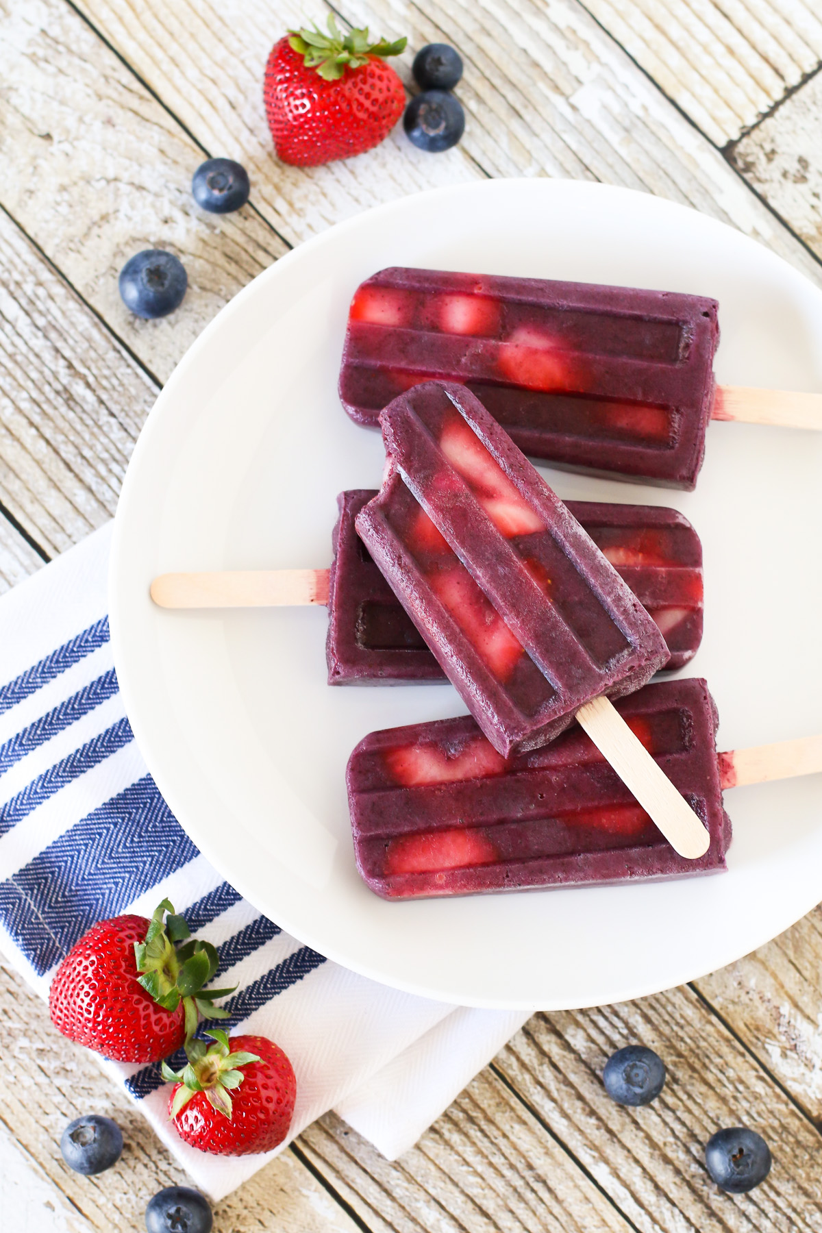 Berry Smoothie Popsicles. These perfect for summer smoothie popsicles are made with blueberries, bananas, flaxmilk and slices of fresh strawberries.