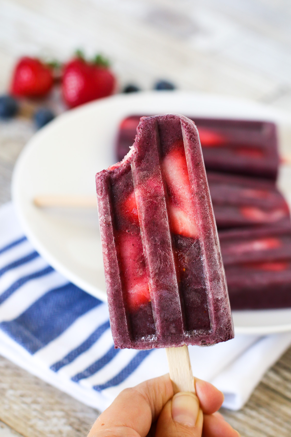 Berry Smoothie Popsicles. These perfect for summer smoothie popsicles are made with blueberries, bananas, flaxmilk and slices of fresh strawberries.