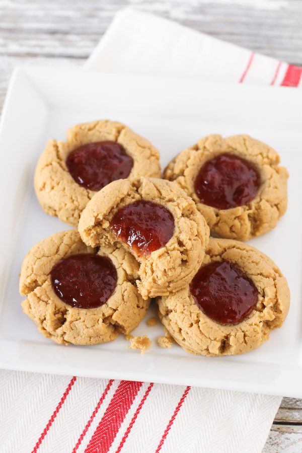 Gluten free vegan peanut butter and jelly thumbprint cookies. Soft peanut butter cookies, filled with your favorite jam. Classic combo!