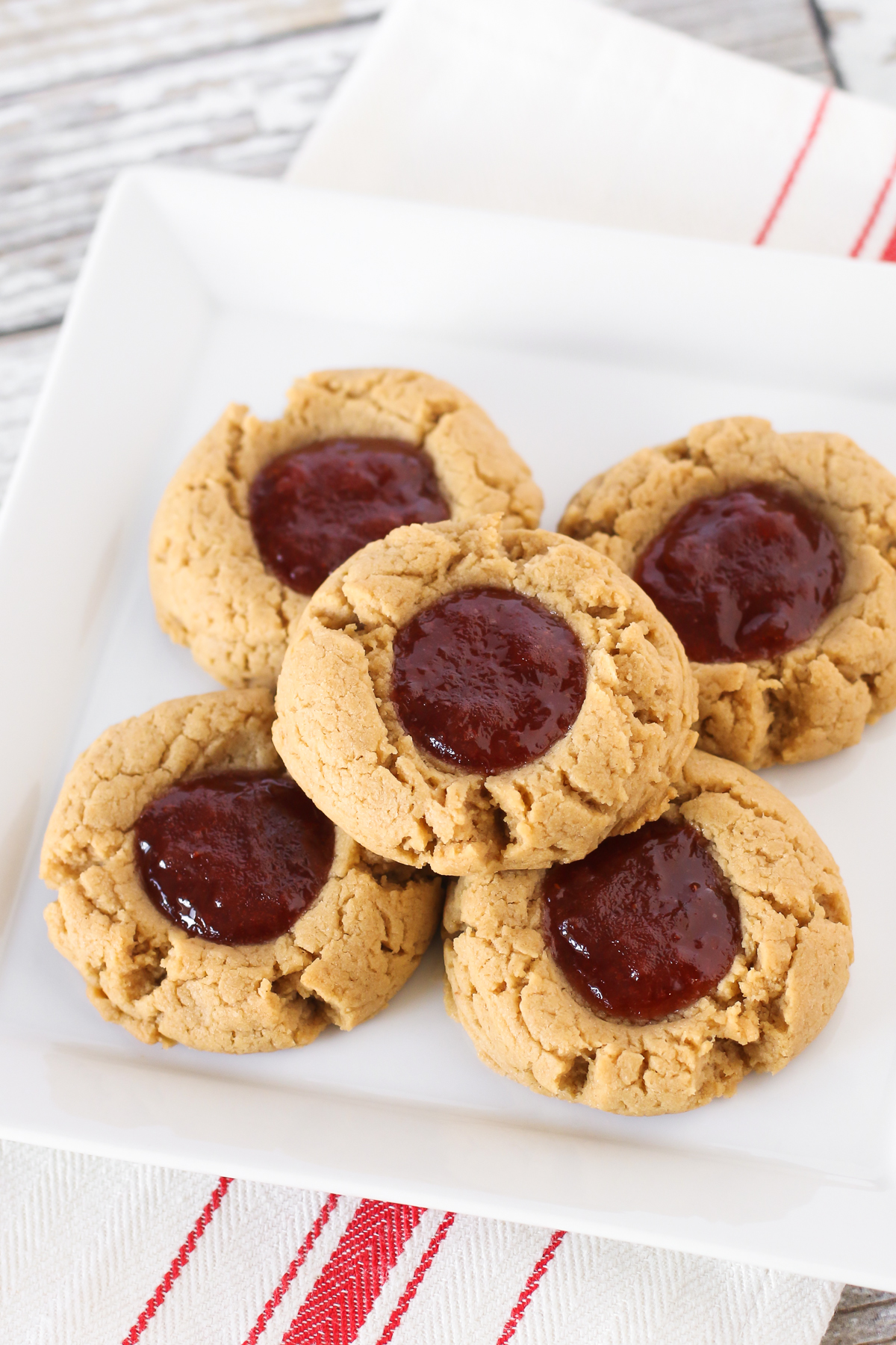 Gluten free vegan peanut butter and jelly thumbprint cookies. Soft peanut butter cookies, filled with your favorite berry jam. The classic combo in a cookie!