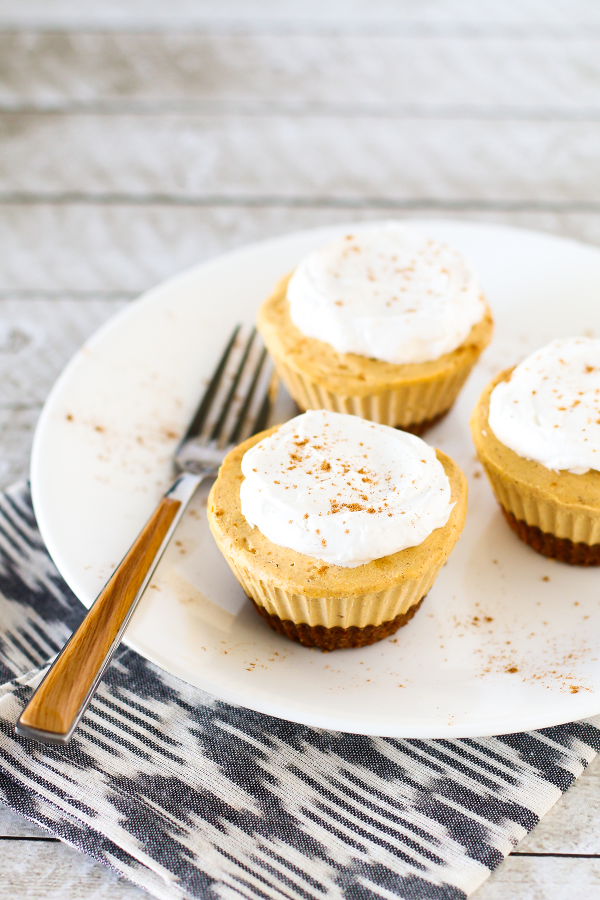 Gluten Free Vegan Mini Pumpkin Cheesecakes. Creamy cashew-based cheesecakes with pumpkin and all the fall spices. 