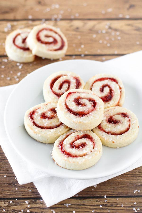 Gluten free vegan raspberry pinwheel cookies. What’s not to love about a sugar cookie with a swirl of sweet raspberry jam and a sprinkling of sparkling sugar?