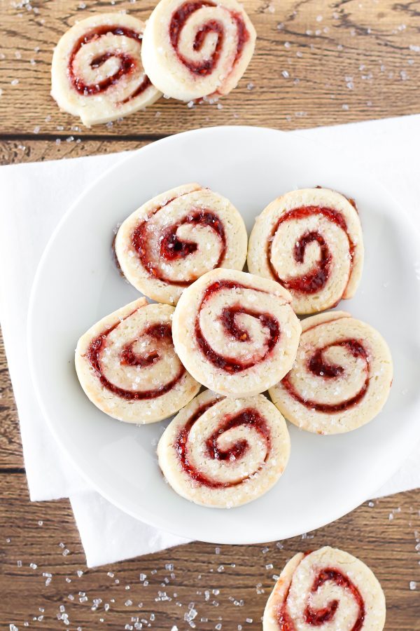 Gluten free vegan raspberry pinwheel cookies. What’s not to love about a sugar cookie with a swirl of sweet raspberry jam and a sprinkling of sparkling sugar?