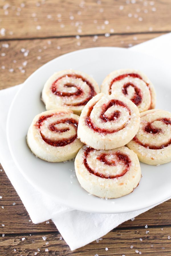 Gluten free vegan raspberry pinwheel cookies. What’s not to love about a sugar cookie with a swirl of sweet raspberry jam and a sprinkling of sparkling sugar?