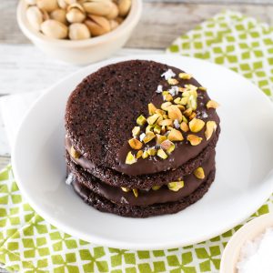 Grain Free Vegan Sea Salt Pistachio Chocolate Cookies. Chewy chocolate almond cookies, dipped in chocolate and sprinkled with chopped pistachios and sea salt.