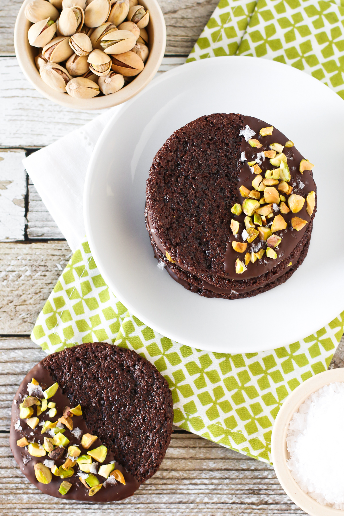 Grain Free Vegan Sea Salt Pistachio Chocolate Cookies. Chewy chocolate almond cookies, dipped in chocolate and sprinkled with chopped pistachios and sea salt. 