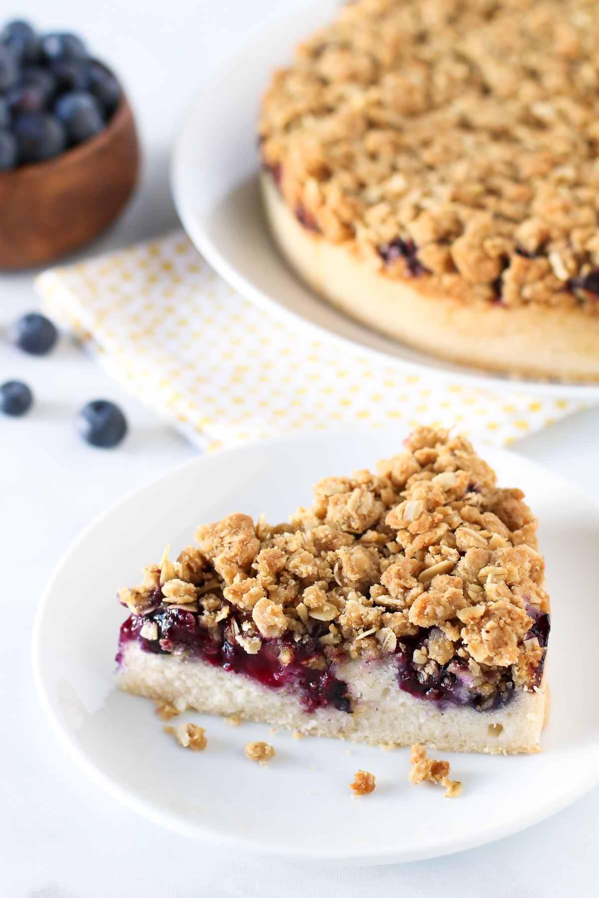 Gluten Free Vegan Blueberry Coffee Cake. Light vanilla cake with a layer of fresh, juicy blueberries and an oat crumb topping.