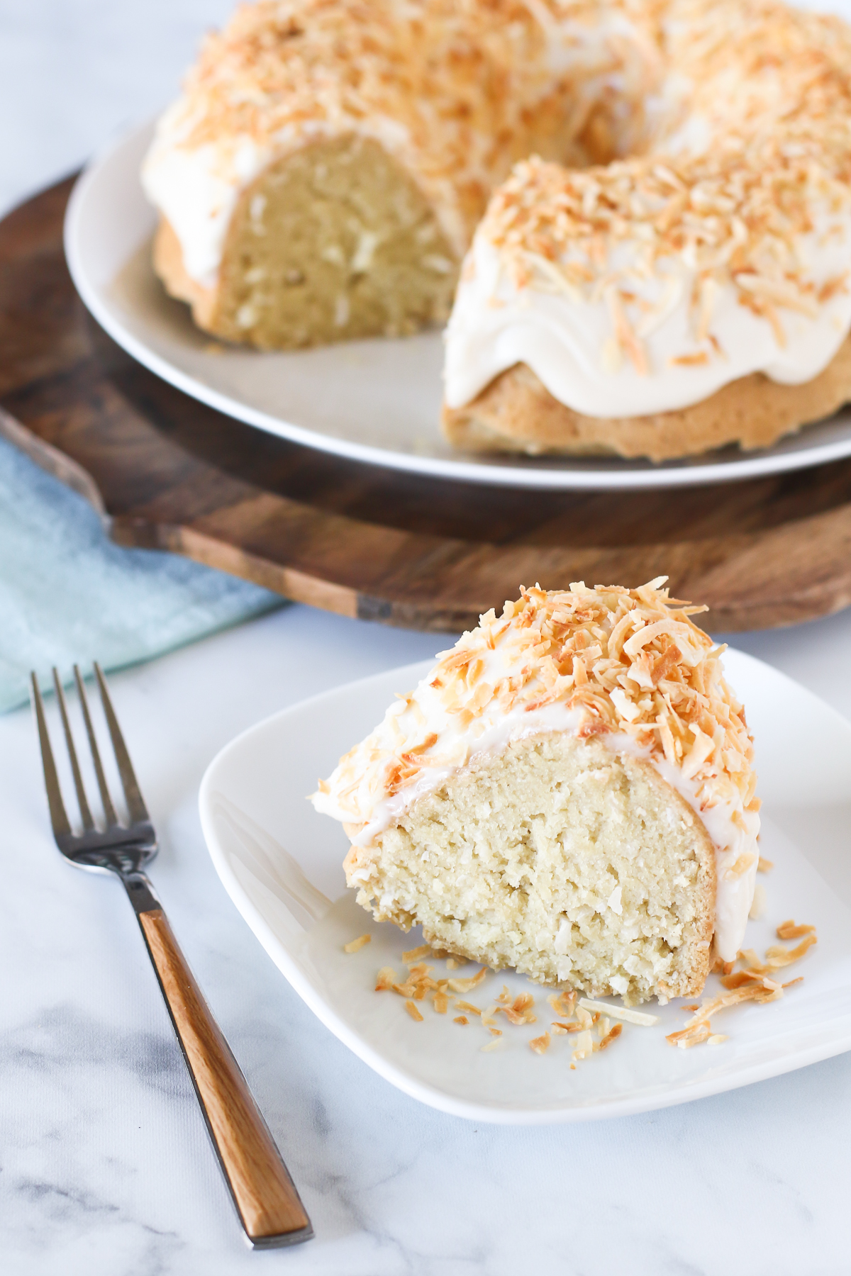 Gluten Free Vegan Coconut Bundt Cake. Give me all the coconut! Coconut cake with a simple frosting and covered in toasted coconut.