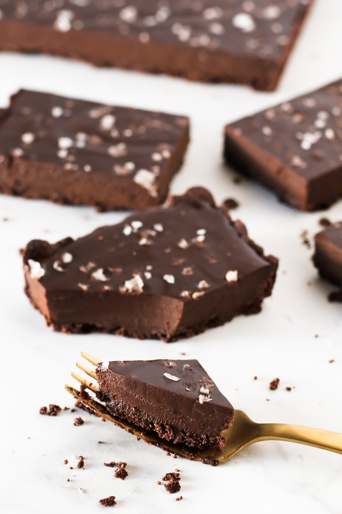 Gluten Free Vegan Salted Dark Chocolate Tart. Cookie crust with a decadent, creamy dark chocolate filling. A sprinkling of flaked sea salt makes this tart irresistible!