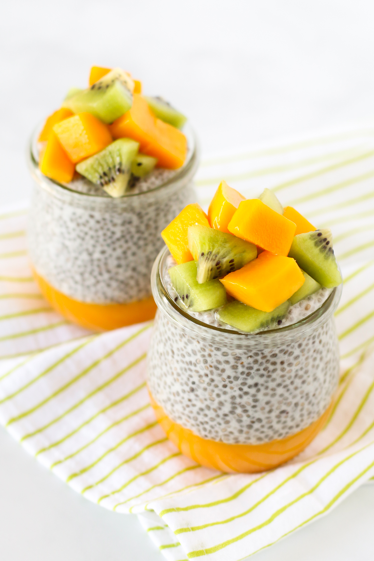 Dairy Free Mango Chia Pudding. Layers of fresh mango puree, vanilla chia seed pudding and fresh fruit. A tropical treat!