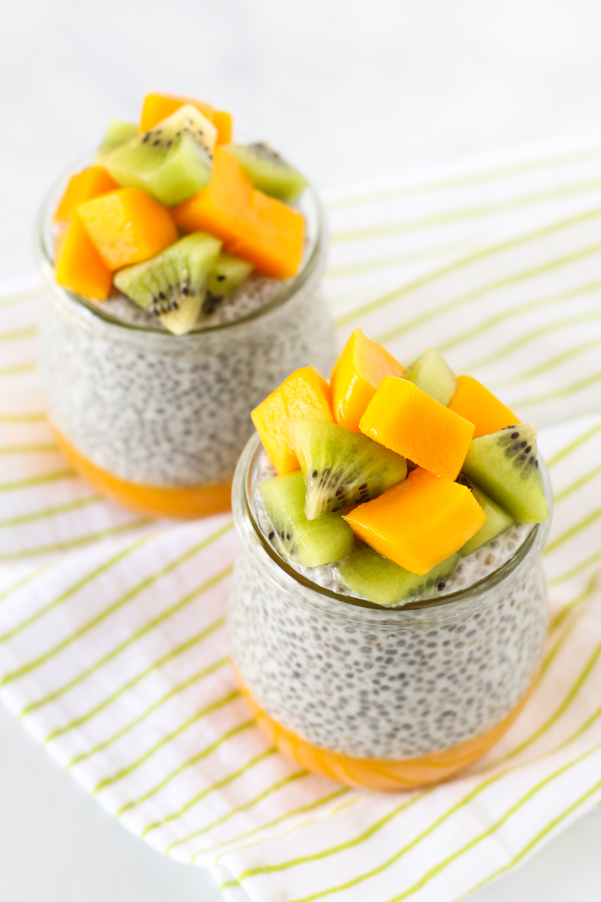 Dairy Free Mango Chia Pudding. Layers of fresh mango puree, vanilla chia seed pudding and fresh fruit. A tropical treat!