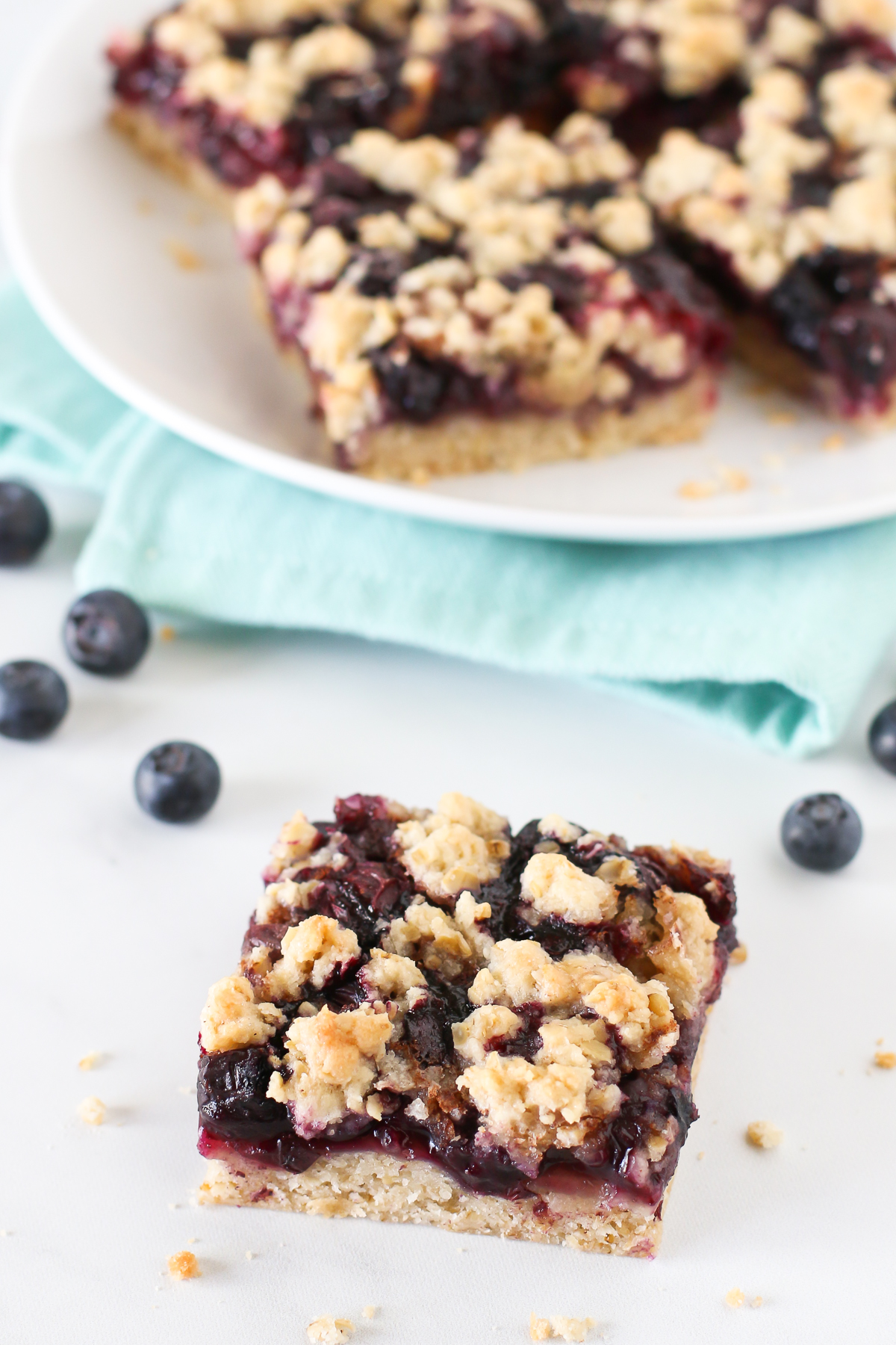 Gluten Free Vegan Blueberry Crumb Bars. Layers of soft, oat crumble and juicy, sweet blueberries with a touch of cinnamon. 