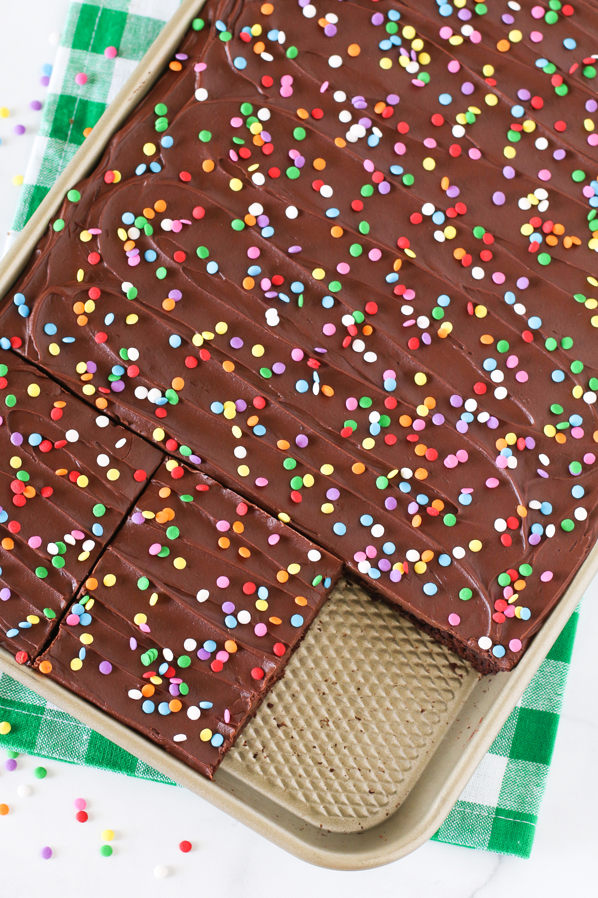 Gluten Free Vegan Chocolate Frosted Brownies. Fudgy, chocolate frosted brownie with colorful sprinkles. The perfect chocolate treat for any celebration!