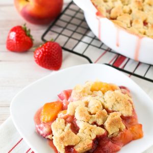 Grain Free Vegan Strawberry Peach Crisp. Golden grain free crisp topping over sweet, juicy strawberries and peaches.