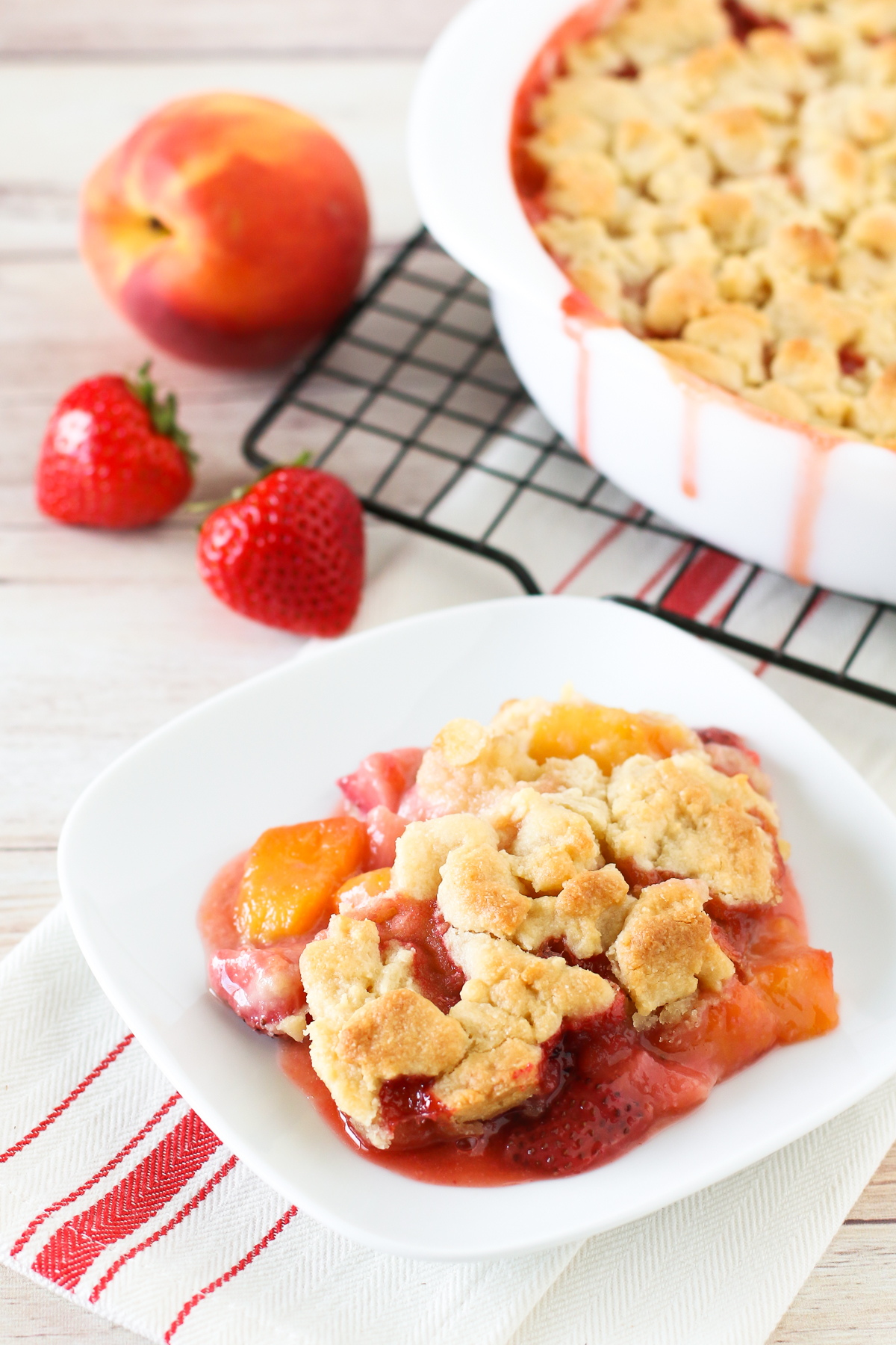 Grain Free Vegan Strawberry Peach Crisp. Golden grain free crisp topping over sweet, juicy strawberries and peaches. 