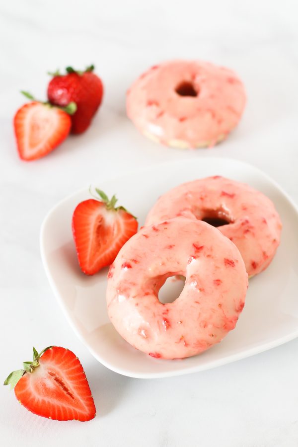 Gluten Free Vegan Baked Strawberry Donuts. Tender baked vanilla donuts with a fresh strawberry glaze. So pretty!