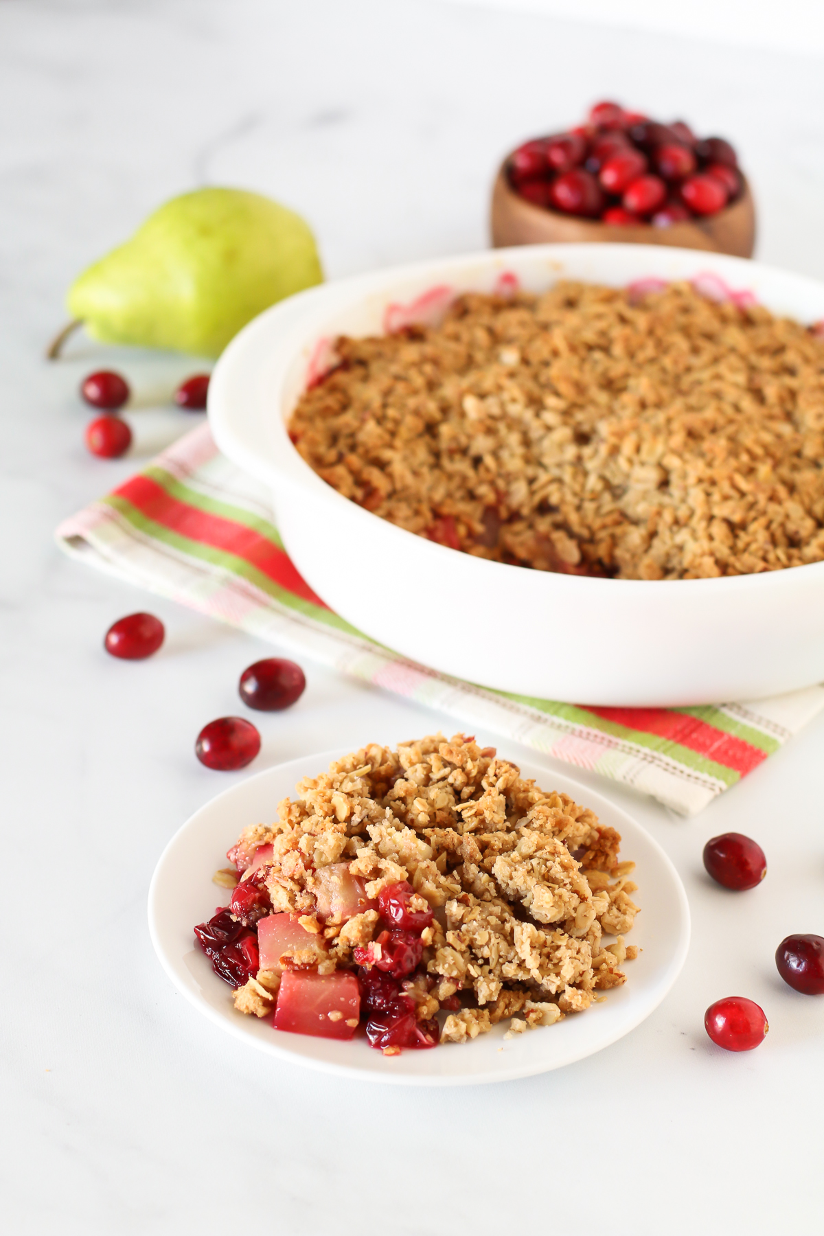 Gluten Free Vegan Cranberry Pear Crisp. Tender pears, tart cranberries and a golden oat-pecan crumb topping. A scrumptious holiday dessert!