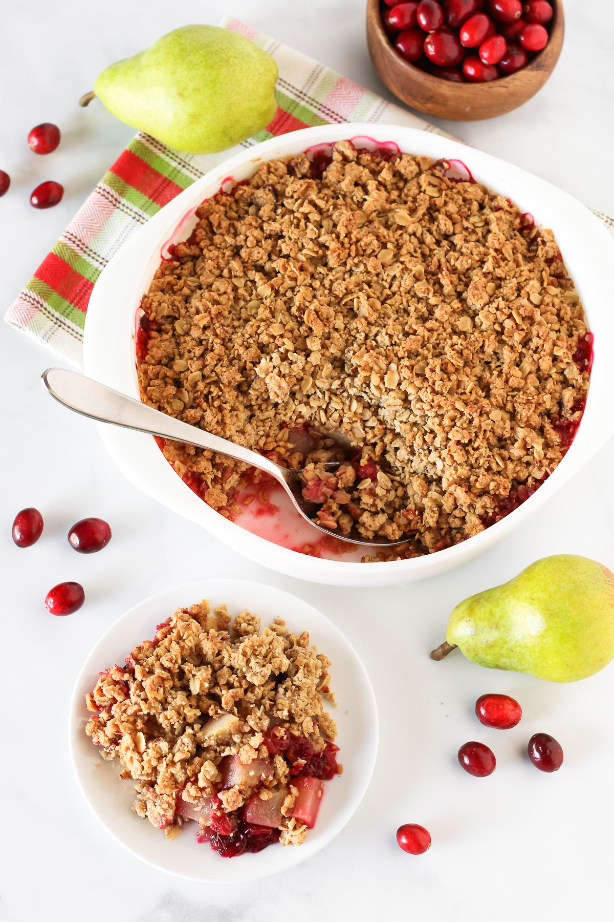 Gluten Free Vegan Cranberry Pear Crisp. Tender pears, tart cranberries and a golden oat-pecan crumb topping. A rustic, easy holiday dessert!