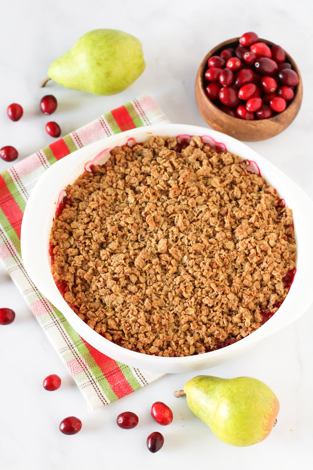 Gluten Free Vegan Cranberry Pear Crisp. Tender pears, tart cranberries and a golden oat-pecan crumb topping. A rustic, easy holiday dessert!