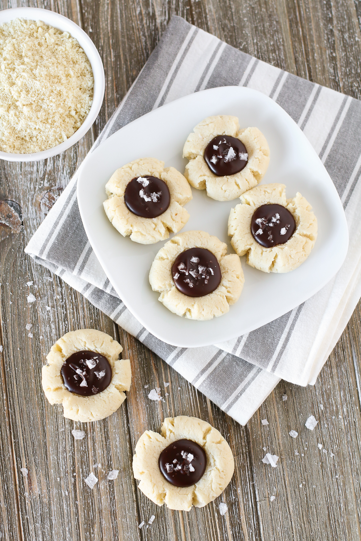 s. Soft almond thumbprint cookies, filled with a decadent chocolate ganache. Those sea salt flakes takes these cookies over the top!