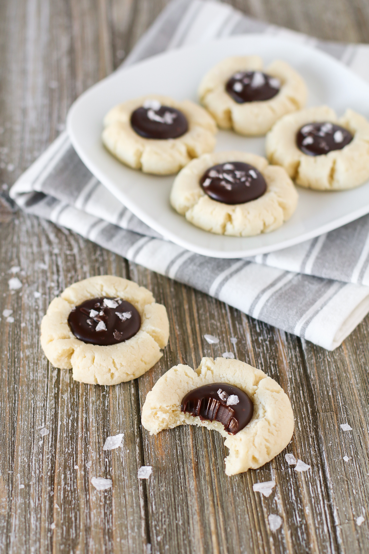 s. Soft almond thumbprint cookies, filled with a decadent chocolate ganache and topped with sea salt flakes.