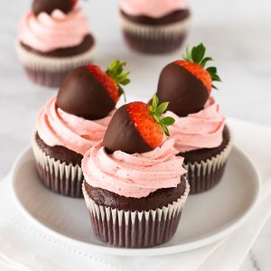 Gluten Free Vegan Chocolate Covered Strawberry Cupcakes. Chocolate cupcakes with a fluffy strawberry buttercream, topped with a beautiful chocolate covered strawberry.