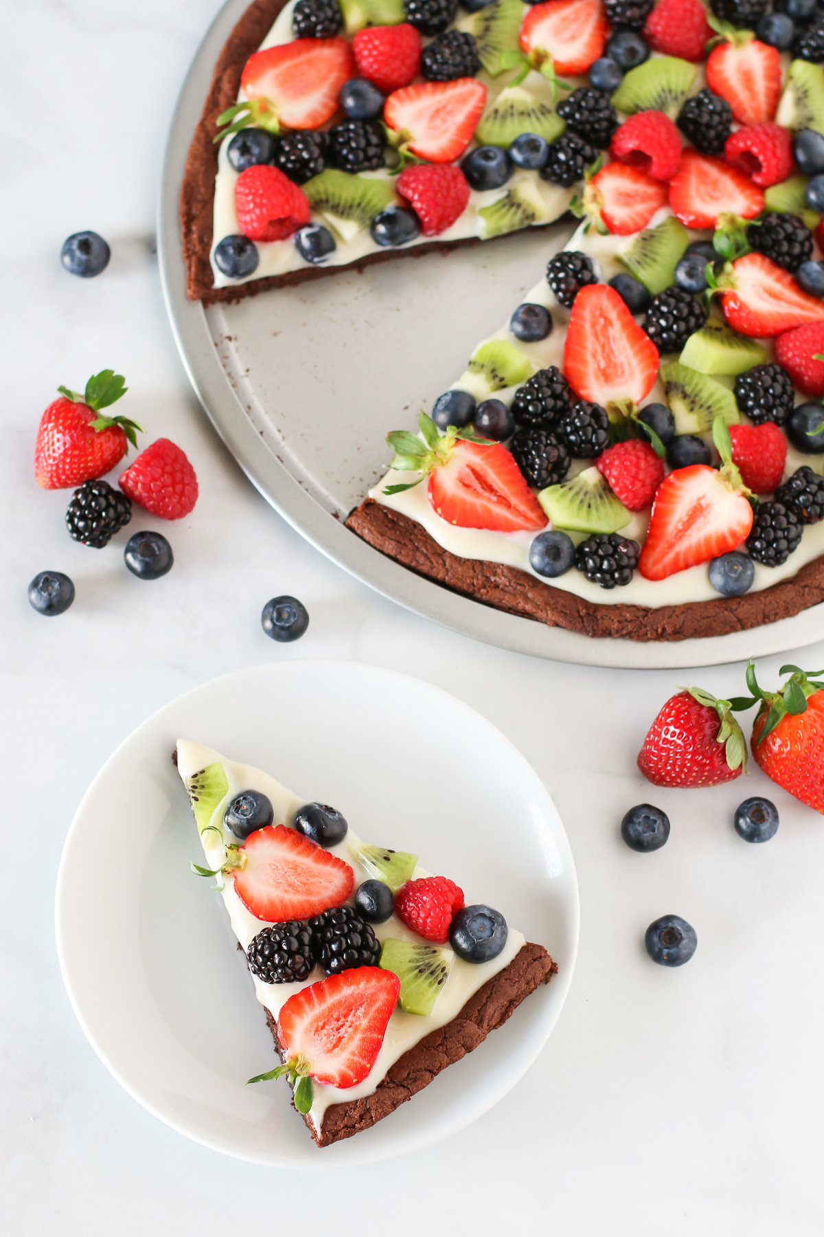 Gluten Free Vegan Brownie Fruit Pizza. Chewy brownie crust with a cream cheese frosting, loaded with fresh fruit. A beautiful dessert pizza!