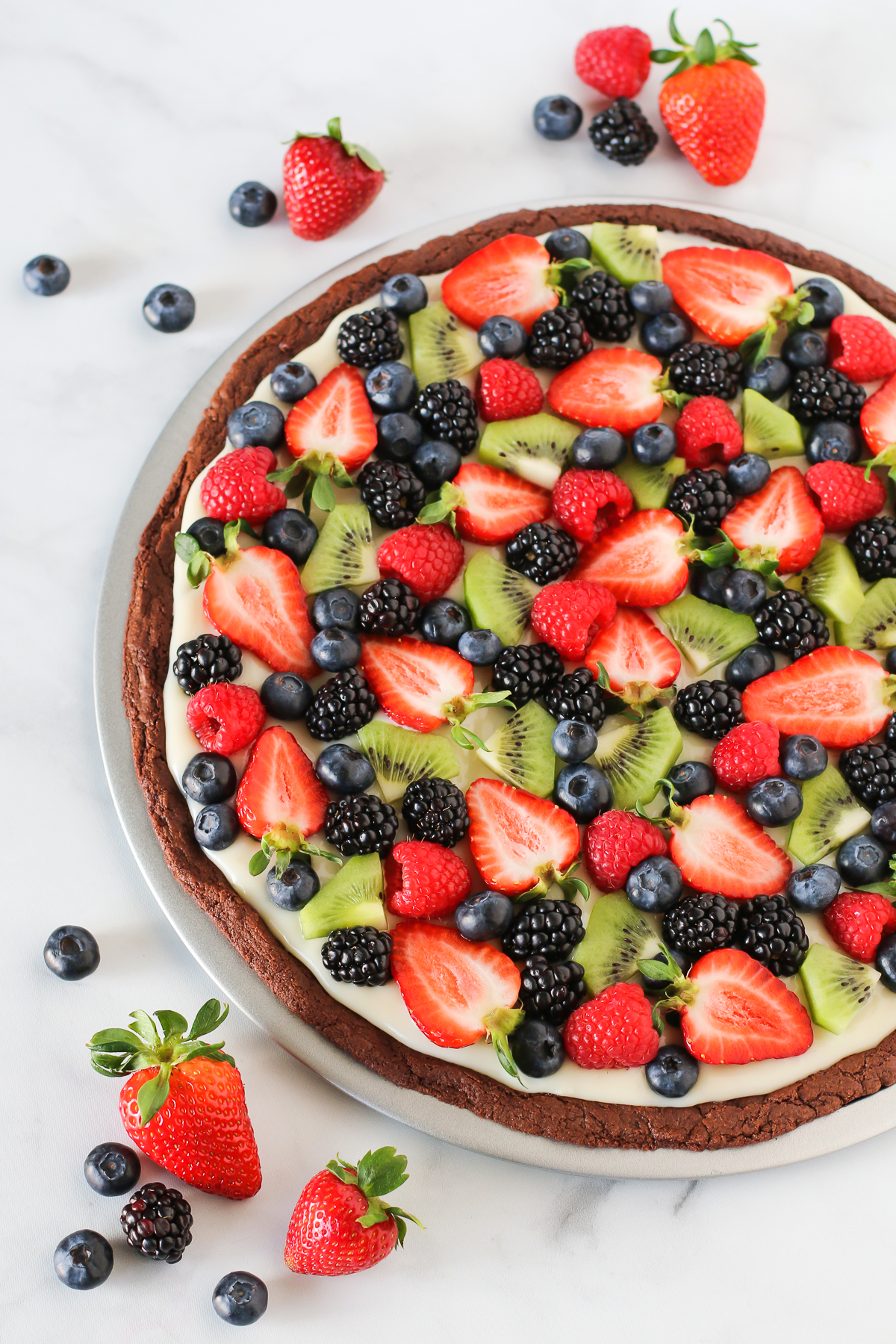 Gluten Free Vegan Brownie Fruit Pizza. Chocolate brownie crust with a cream cheese frosting, loaded with fresh fruit. A beautiful dessert pizza!