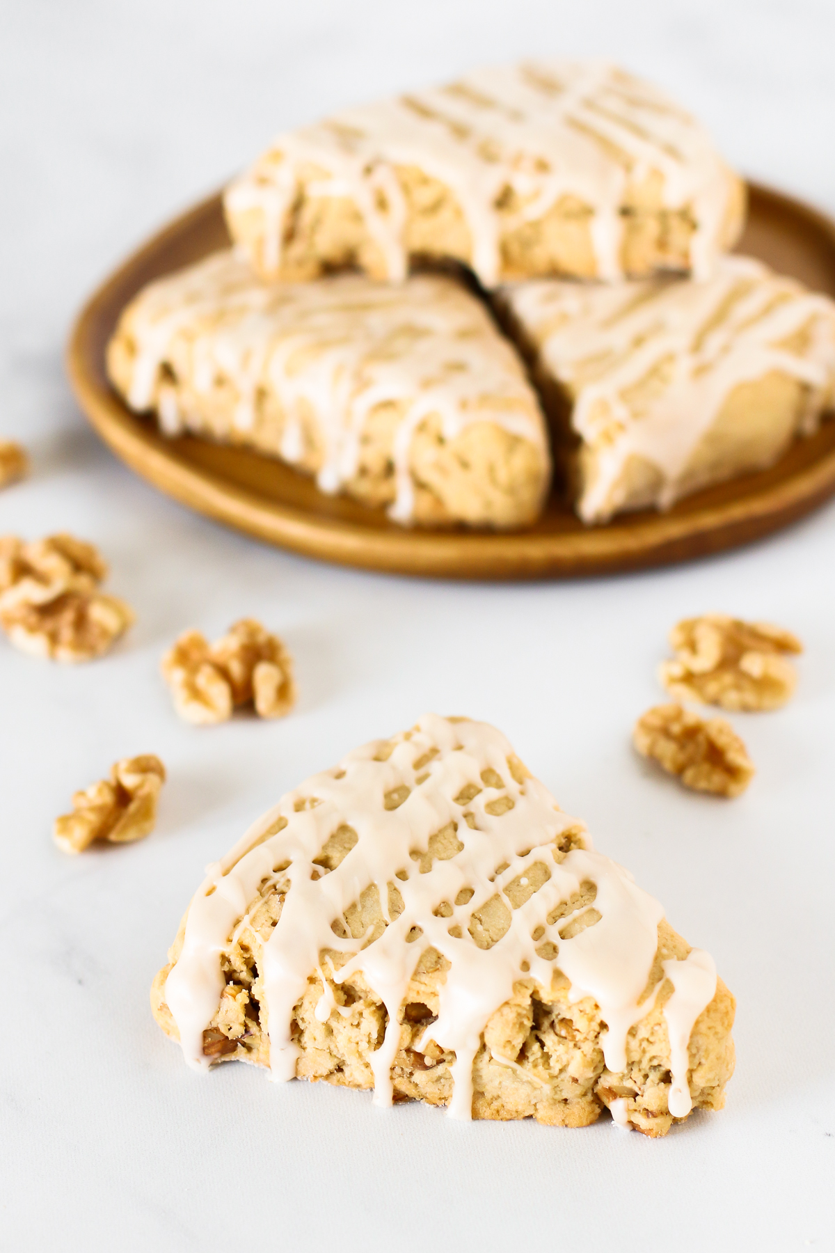 Gluten Free Vegan Maple Walnut Scones. Tender scones with toasted walnuts, covered in a delicious maple glaze.